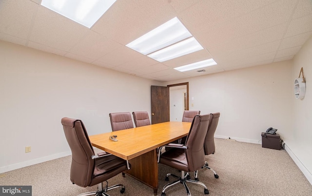 carpeted office space featuring a drop ceiling