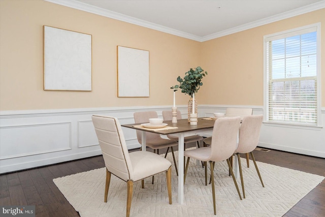 dining area featuring dark hardwood / wood-style flooring and ornamental molding