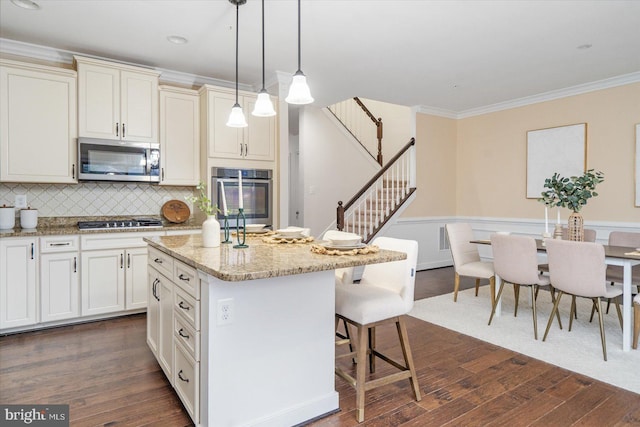 kitchen featuring a center island, dark hardwood / wood-style flooring, and appliances with stainless steel finishes