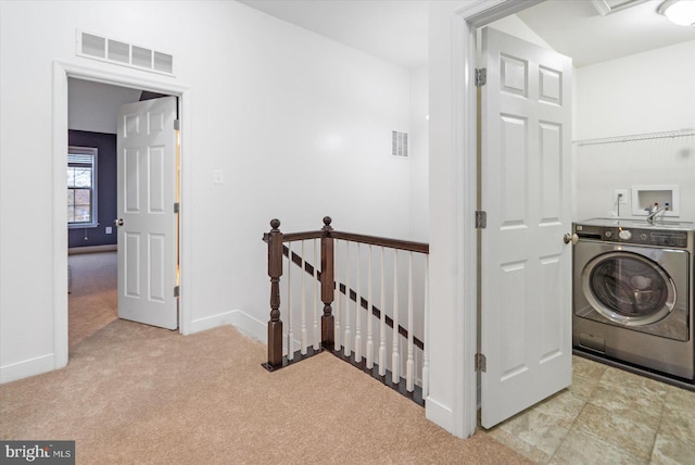 washroom with washer / clothes dryer and light carpet