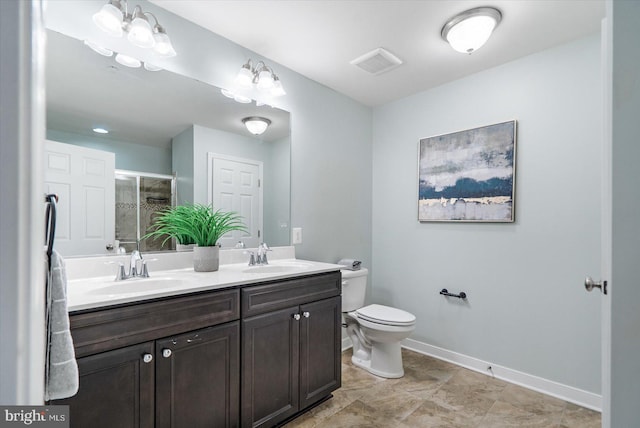 bathroom featuring vanity, toilet, and walk in shower