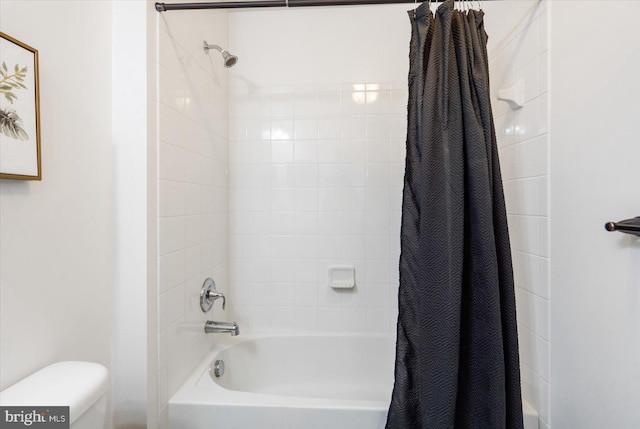 bathroom with shower / tub combo and toilet