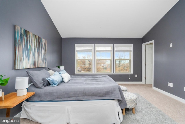 carpeted bedroom with vaulted ceiling