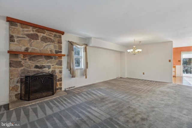 unfurnished living room featuring carpet flooring, an inviting chandelier, and a stone fireplace