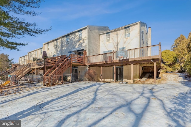 rear view of house featuring a wooden deck