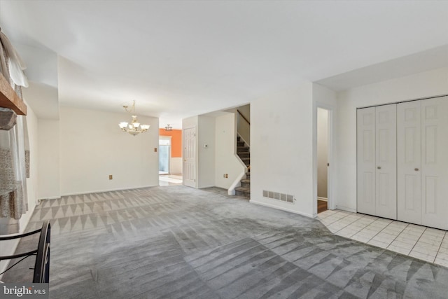 unfurnished living room with light tile patterned floors and a notable chandelier