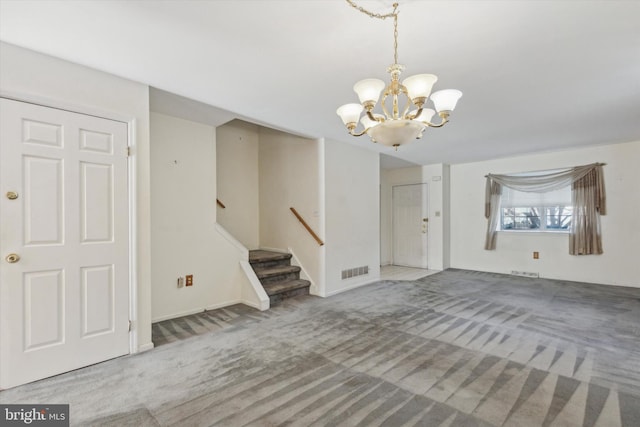 foyer featuring carpet floors and an inviting chandelier