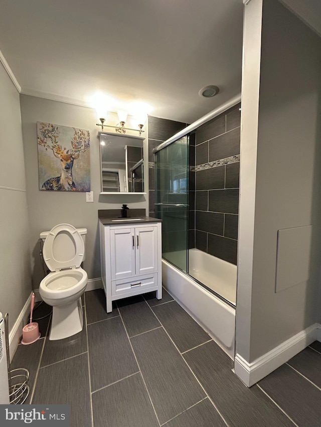 full bathroom with vanity, enclosed tub / shower combo, and toilet