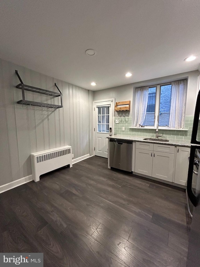 kitchen with dishwasher, radiator heating unit, sink, dark hardwood / wood-style flooring, and white cabinetry