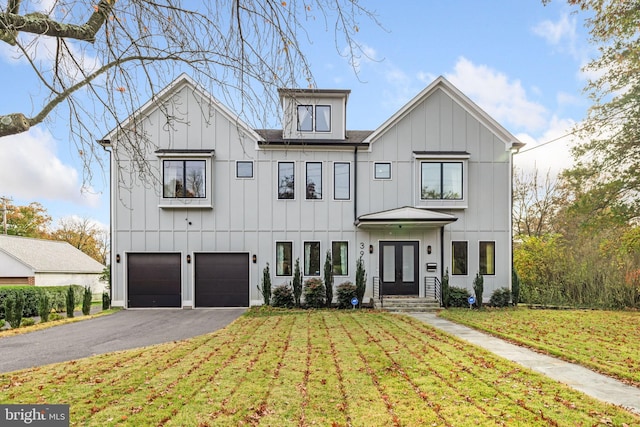 modern farmhouse style home with a front yard and a garage