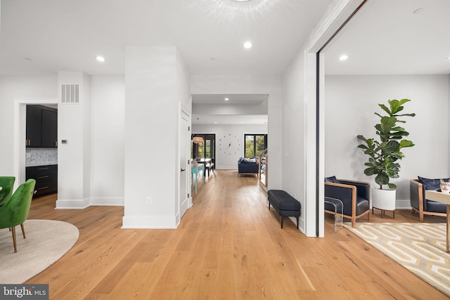 corridor with light hardwood / wood-style flooring