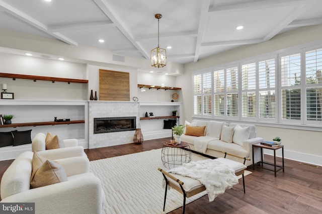 living room with dark wood-type flooring, a wealth of natural light, and a fireplace