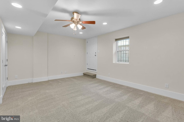 spare room with light carpet and ceiling fan