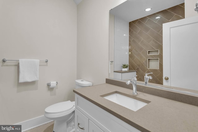 bathroom featuring vanity, tile patterned flooring, and toilet