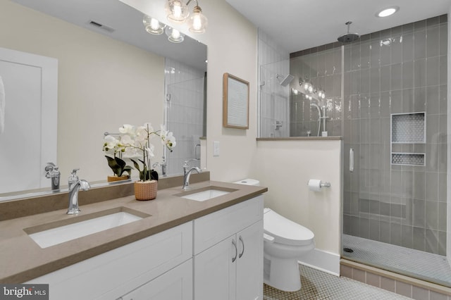 bathroom with walk in shower, vanity, toilet, and tile patterned flooring