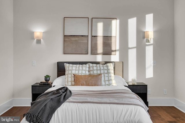 bedroom with dark wood-type flooring