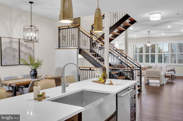 kitchen featuring an inviting chandelier, dark hardwood / wood-style floors, sink, and hanging light fixtures