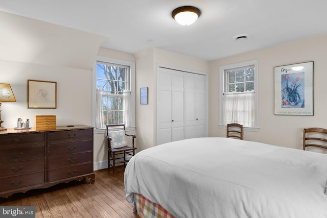 bedroom featuring dark hardwood / wood-style flooring and a closet