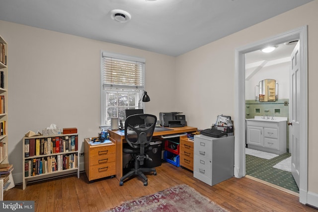 office with light wood-type flooring