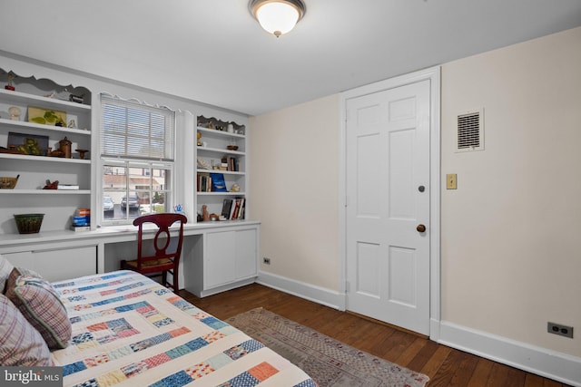 bedroom featuring dark hardwood / wood-style floors and built in desk