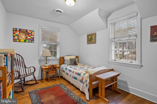 bedroom featuring vaulted ceiling and hardwood / wood-style floors