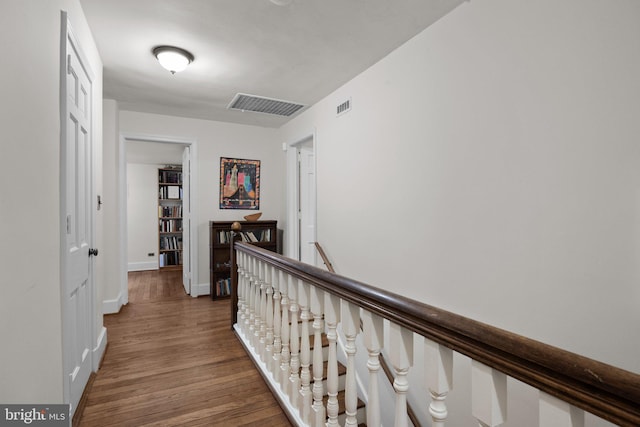 corridor with dark hardwood / wood-style flooring