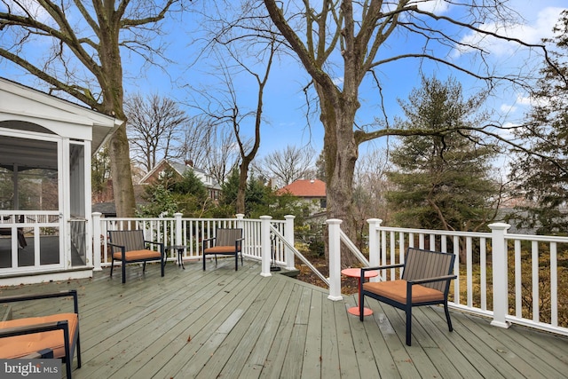 wooden terrace featuring a sunroom