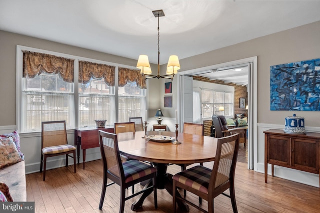 dining space with a notable chandelier and wood-type flooring