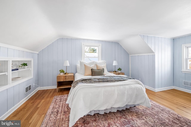 bedroom with light hardwood / wood-style floors and vaulted ceiling