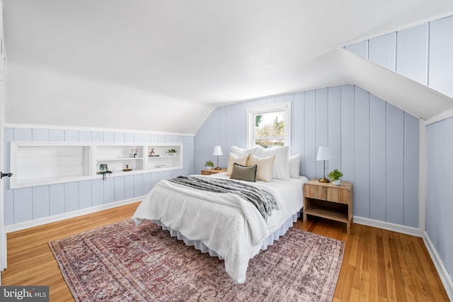 bedroom featuring vaulted ceiling and hardwood / wood-style floors