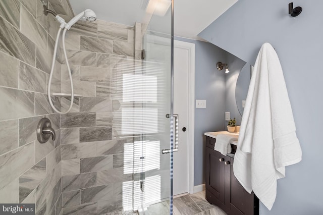 bathroom featuring vanity and a tile shower