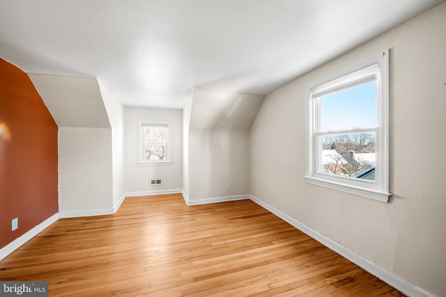 bonus room featuring light hardwood / wood-style floors and vaulted ceiling