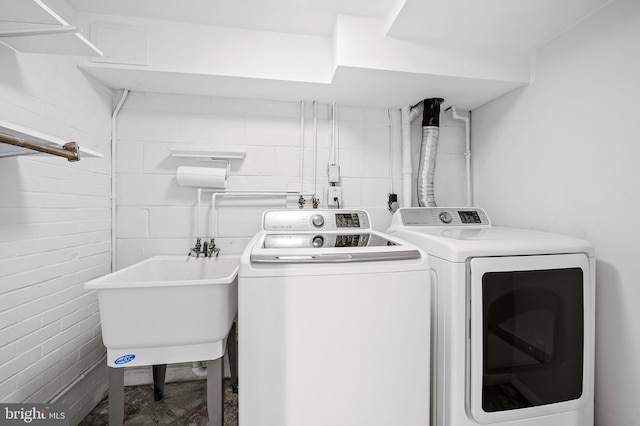 laundry room featuring sink and separate washer and dryer