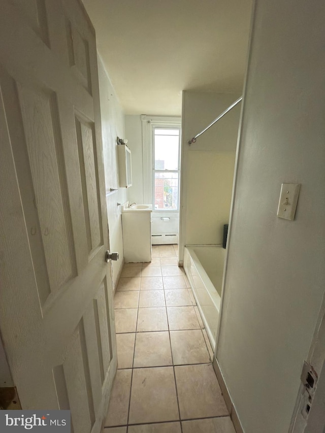 bathroom with tile patterned flooring, vanity, and a baseboard radiator