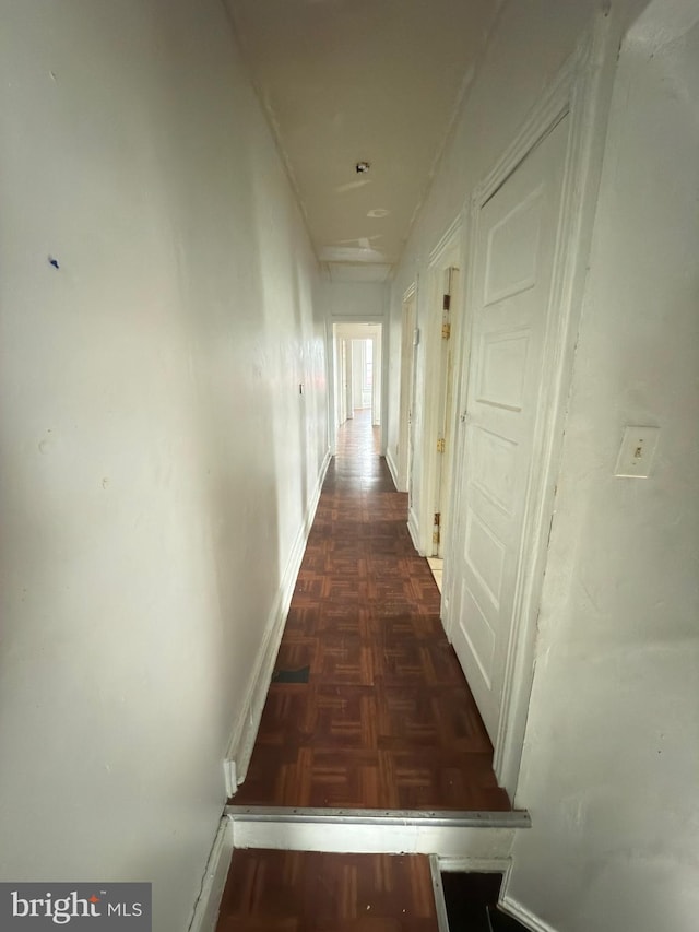 hallway with dark parquet floors