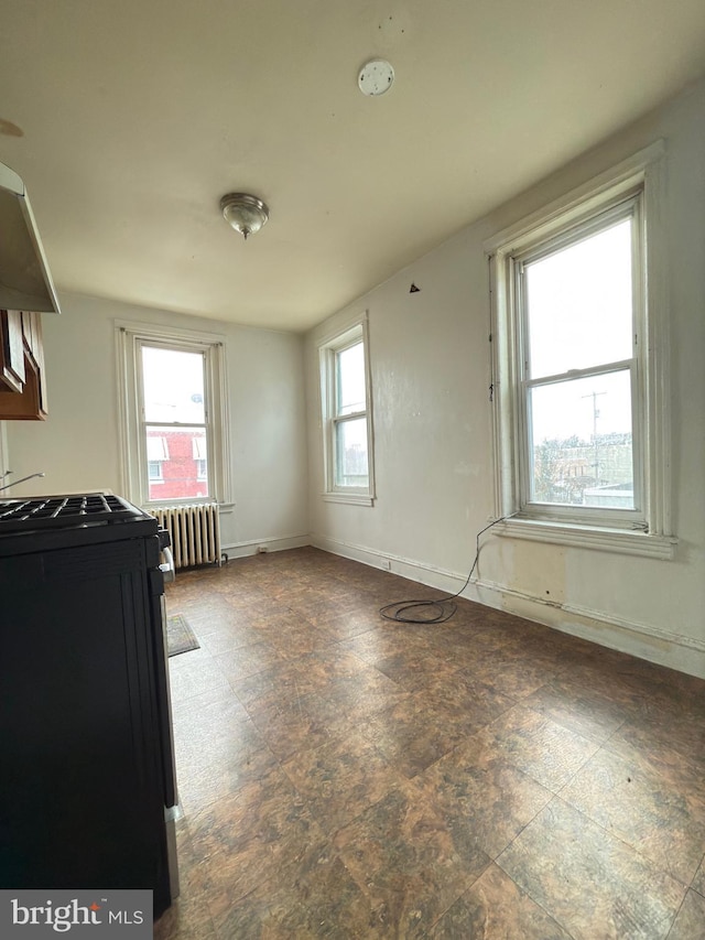 unfurnished dining area featuring radiator heating unit