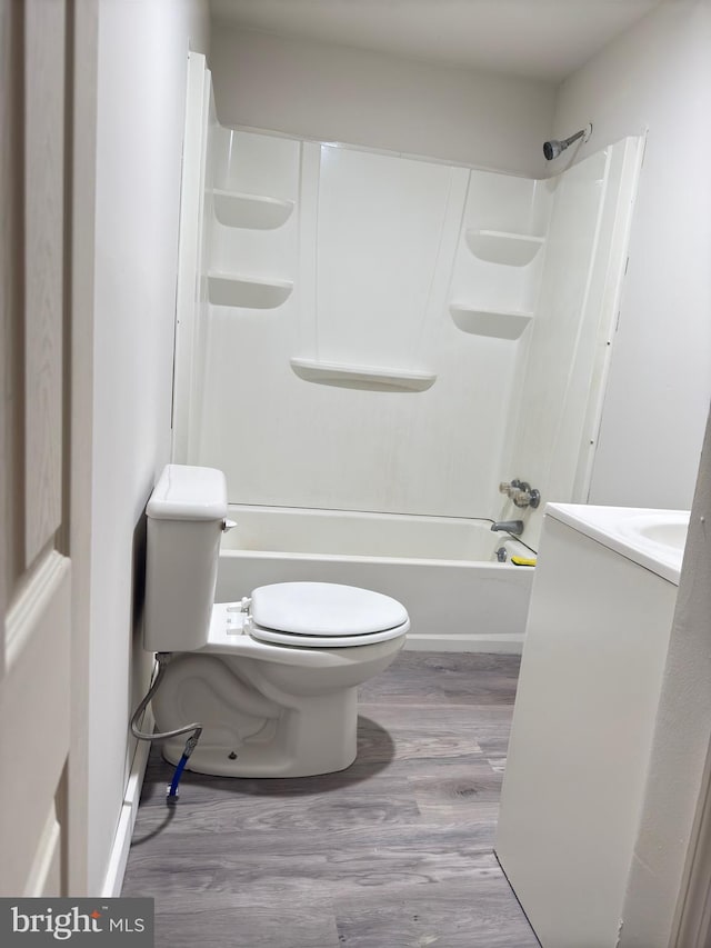 full bathroom featuring vanity, toilet, wood-type flooring, and shower / tub combination