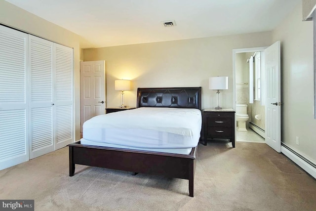 carpeted bedroom with connected bathroom, a closet, and a baseboard heating unit