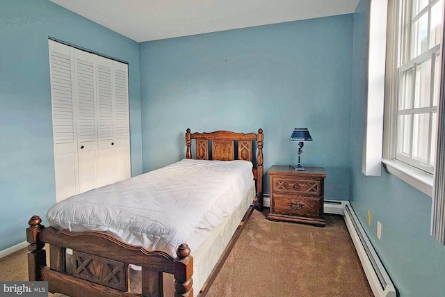 bedroom with carpet flooring, a baseboard radiator, and a closet