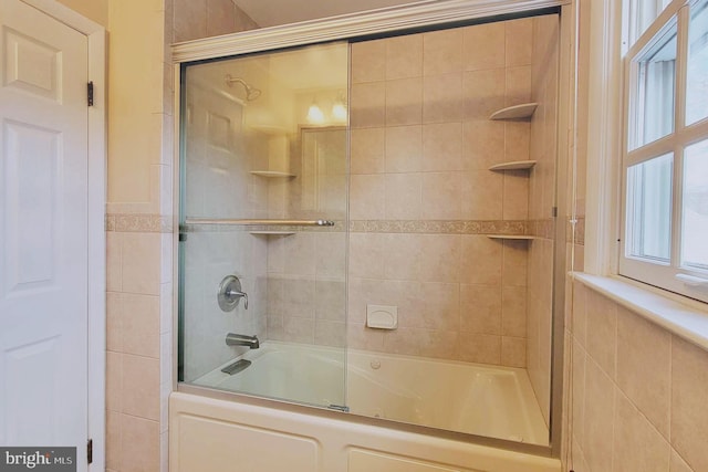 bathroom featuring combined bath / shower with glass door