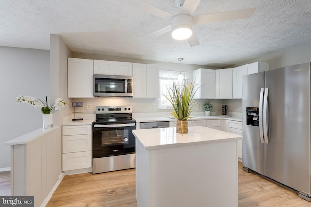 kitchen with stainless steel appliances, a center island, and white cabinets