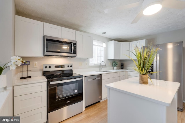 kitchen with sink, white cabinets, and appliances with stainless steel finishes