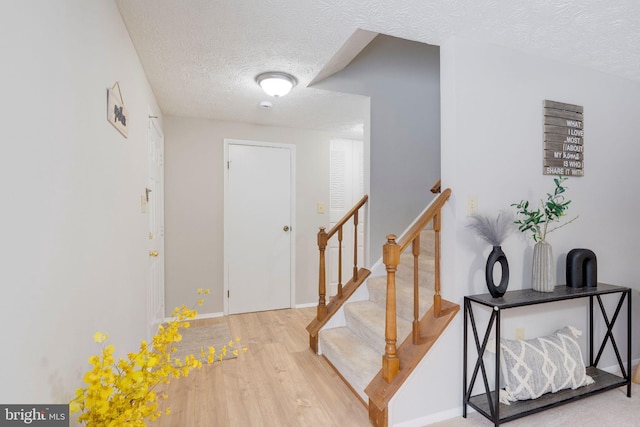 entryway featuring hardwood / wood-style floors and a textured ceiling