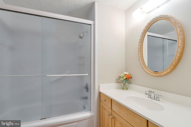 bathroom with vanity and a shower with door