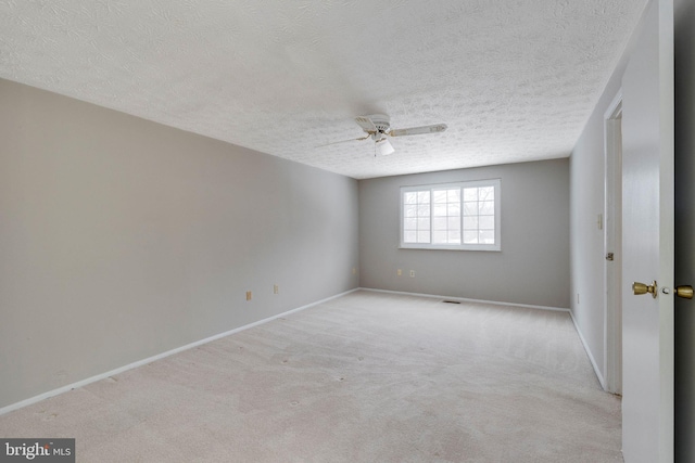 carpeted empty room featuring a textured ceiling and ceiling fan