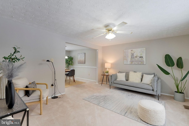 carpeted living room with a textured ceiling and ceiling fan