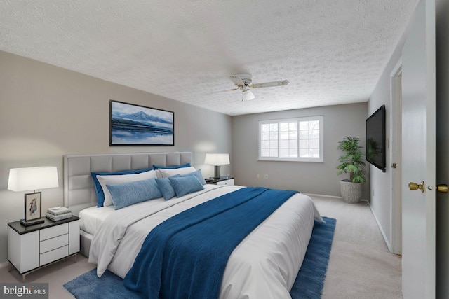 carpeted bedroom with a textured ceiling and ceiling fan