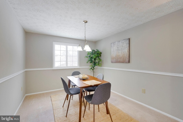 dining area with light carpet, a textured ceiling, and an inviting chandelier