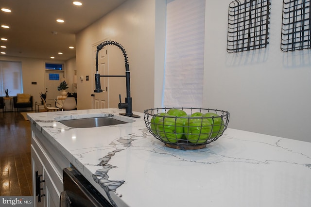 kitchen with light stone counters and sink