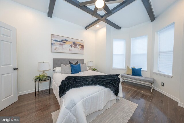 bedroom featuring beamed ceiling, ceiling fan, dark hardwood / wood-style floors, and multiple windows